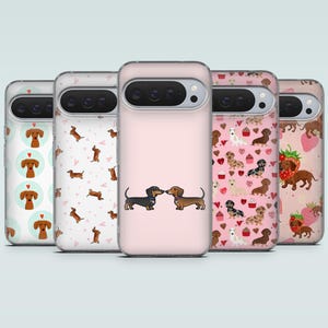 May include: A collection of phone cases with various dachshund-themed designs. The cases feature patterns of dachshunds, hearts, strawberries, and cupcakes. The color palette includes pink, white, and brown.