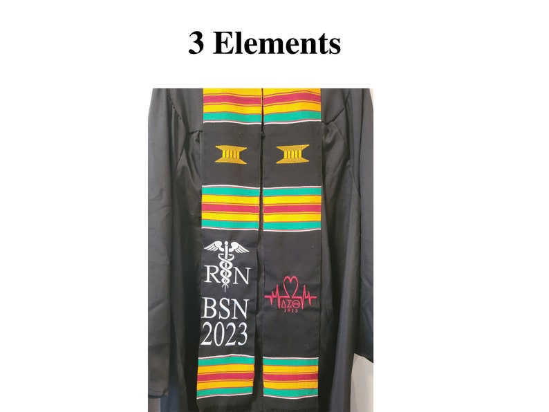 May include: Black graduation stole with colorful stripes of green, yellow, and red. The stole features white text that reads "R N BSN 2023" and a caduceus symbol. Another section has a pink heart symbol and the text "&Delta;&Sigma;&Theta; 2023". The words "3 Elements" are at the top.