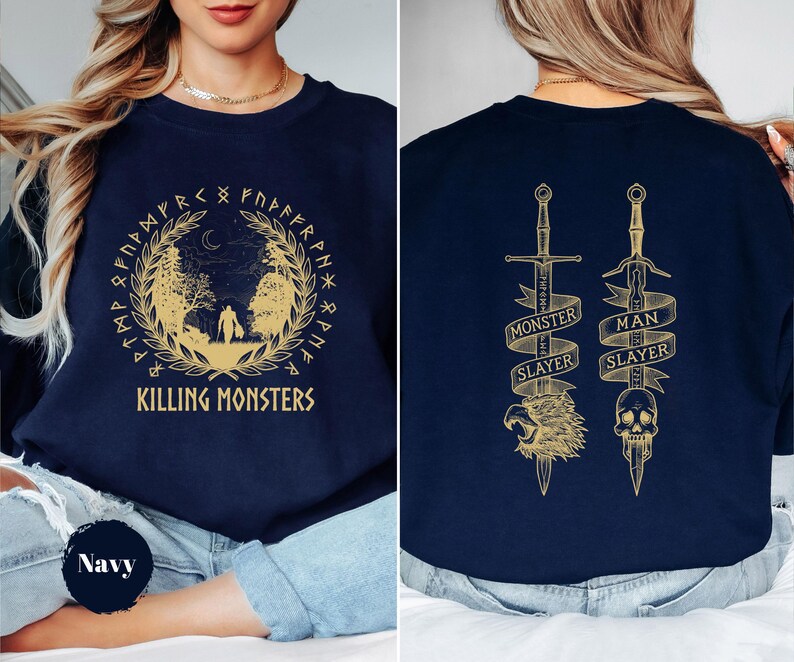 May include: Navy blue sweatshirt with a gold design. The front features a circular design with the text "Killing Monsters". The back has two swords with the text "Monster Slayer" and "Man Slayer".