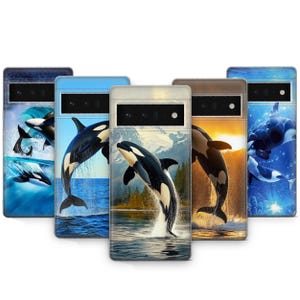 May include: Five different phone cases featuring a black and white orca whale jumping out of the water. The cases have different backgrounds, including a blue ocean, a snowy mountain scene, and a waterfall.