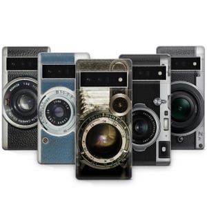 May include: Five different phone cases with vintage camera designs. The cases are black, blue, and brown with silver accents. The cameras on the cases have different lenses and details.