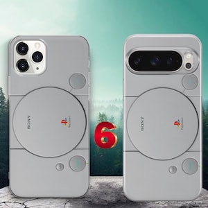 May include: Two light gray smartphone cases featuring a retro gaming console design. Each case displays the Sony and PlayStation logos, a circular disc cover graphic, and small circular buttons labeled Reset and Power in a light gray finish.