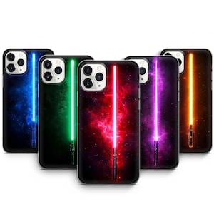May include: Five different phone cases with a galaxy background and a lightsaber in the center. The lightsabers are blue, green, red, purple, and orange.