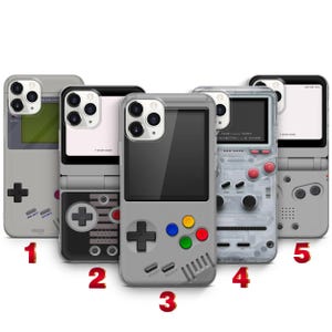 May include: Five smartphone cases featuring retro handheld gaming console designs. Each case displays a unique layout of directional pads, action buttons, and screen graphics. The designs include various color schemes like grey, black, and transparent.