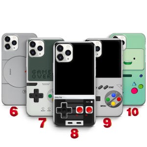 May include: Five smartphone cases featuring retro gaming console designs. The cases display various layouts including a gray Sony-inspired design, a Game Over screen, a black Delta controller, a gray controller with colored buttons, and a green character.