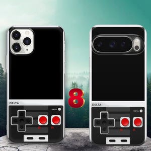May include: Two smartphone cases featuring a black top section and a bottom section designed to look like a retro video game controller. The controller graphic includes a black directional pad, two red buttons labeled A and B, and the word DELTA.