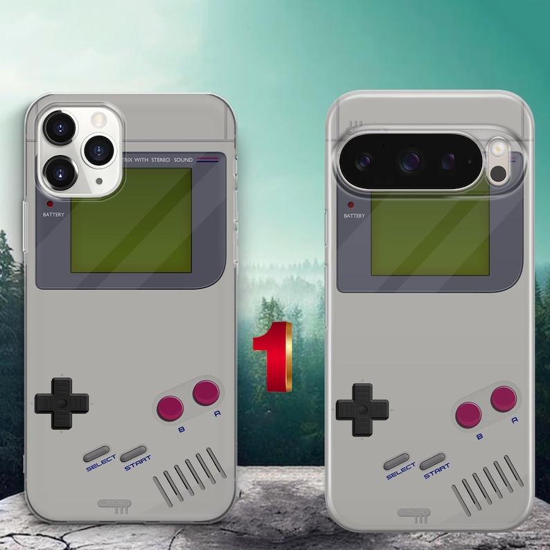 May include: Two light gray phone cases featuring a retro handheld gaming console design. Each case displays a dark gray screen area, a black directional pad, two purple A and B buttons, and gray Select and Start buttons with printed text.