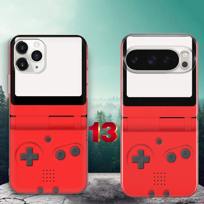 May include: Two red phone cases designed to resemble a handheld gaming console. Each case features a directional pad, A and B buttons, and a speaker grille. The top portion of each case is white, accommodating the specific camera cutouts for two different phone models.