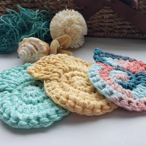 May include: Four crocheted scrubbies in different colors and patterns. The scrubbies are in the shape of a leaf and are made with a soft, textured yarn. They are perfect for cleaning dishes, counters, and other surfaces.