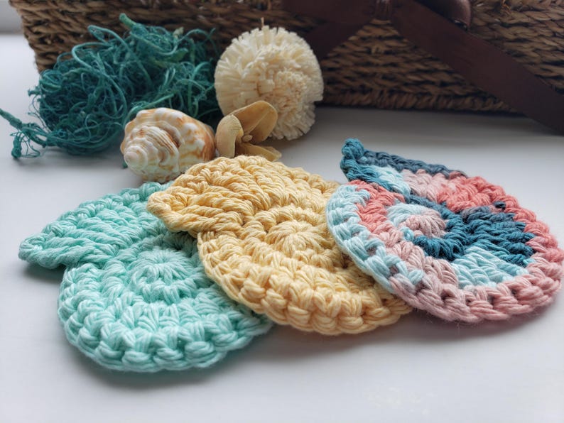 May include: Four crocheted scrubbies in different colors and patterns. The scrubbies are in the shape of a leaf and are made with a soft, textured yarn. They are perfect for cleaning dishes, counters, and other surfaces.