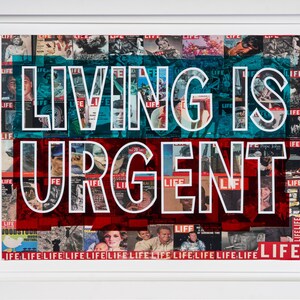 May include: Framed artwork featuring the text "LIVING IS URGENT" in white block letters. The background is a collage of vintage LIFE magazine covers, with a blue and red colour scheme. The artwork is encased in a white frame.