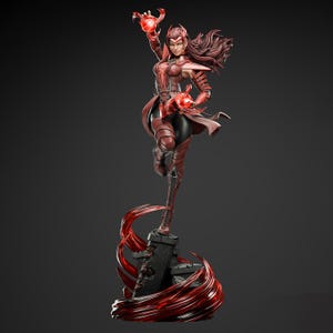 May include: A red and black statue of a female superhero in a dynamic pose. The figure is wearing a red costume with black accents and is standing on a stone base with red energy effects. The statue is approximately 30 cm tall.
