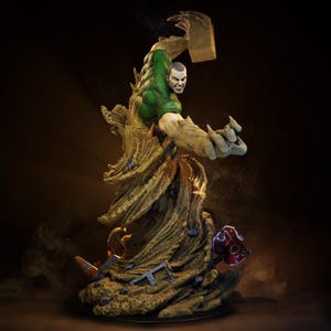 May include: A detailed statue of a muscular figure with green and tan coloring, posed in an action stance. The figure is emerging from a swirling, textured base, with a menacing expression. The statue has a dynamic, comic book style.