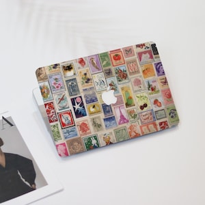 May include: Laptop skin covered in a collage of vintage postage stamps. The stamps feature various designs, including flowers, animals, and landmarks, in a variety of colors. The Apple logo is visible.