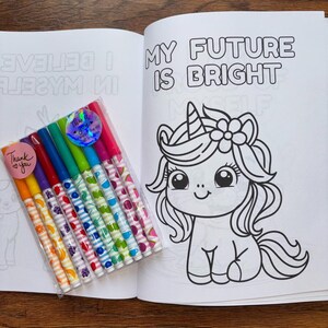 May include: A coloring book with a unicorn on the cover. The book has the words "My Future is Bright" on the cover. The book comes with a set of eight colorful markers with fruit designs.