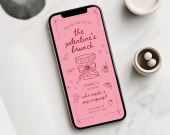 May include: A smartphone displays a pink Galentine's brunch invitation with red line art. The invitation includes text, a cocktail glass illustration, cherries, and a strawberry. The phone is on a white marble surface.