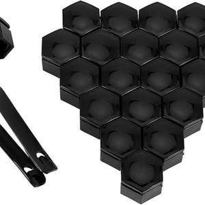 May include: A set of black plastic hexagonal wheel covers. The covers are arranged in a honeycomb pattern.