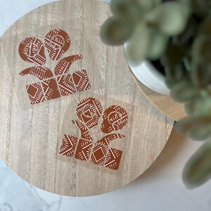 May include: Two brown and white patterned gift box stickers on a wooden surface.