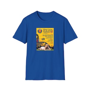 May include: Royal blue t-shirt featuring a colorful graphic from the "One Love Festival 10" event. The graphic includes text, a woman, and a roller coaster design. The shirt is made of a soft material.