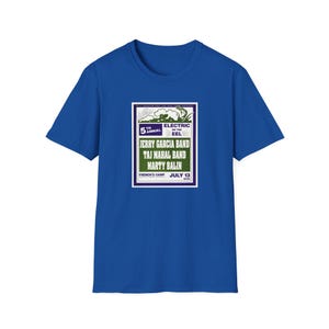 May include: A royal blue t-shirt featuring a rectangular graphic with the text "5th Annual Electric Eel" and the names of musical artists Jerry Garcia Band, Taj Mahal Band, and Marty Balin. The graphic is in white, green, and purple.