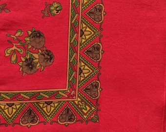 Portuguese red fabric with ethnic floral motif in brown, green and yellow. Cachené, unfinished shawl, fabric for folk costume from Portugal