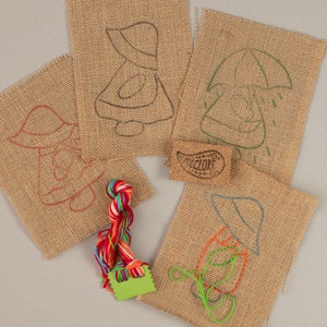 Kinder Stickpackung mit Sunbonnet Sue Motiven auf Sackleinen. DIY Bastel-Rückstich-Anleitung mit Wollgarn, Sackleinen- & Puppenmotiven.
