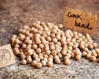 Natural round cork beads for sustainable & eco-friendly jewellery. 10mm small balls w/ different hole sizes. Portuguese cork for DIY crafs