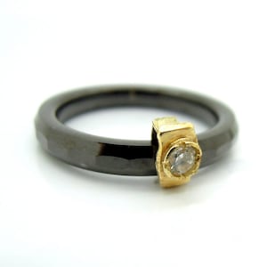 Black ceramic ring with a zircon set in 9K Gold