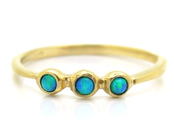 Opal engagement ring set in yellow gold