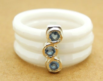 White ceramic stacking ring with blue topaz stones in sterling silver