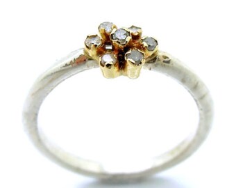 Diamond engagement ring set in gold and a silver band