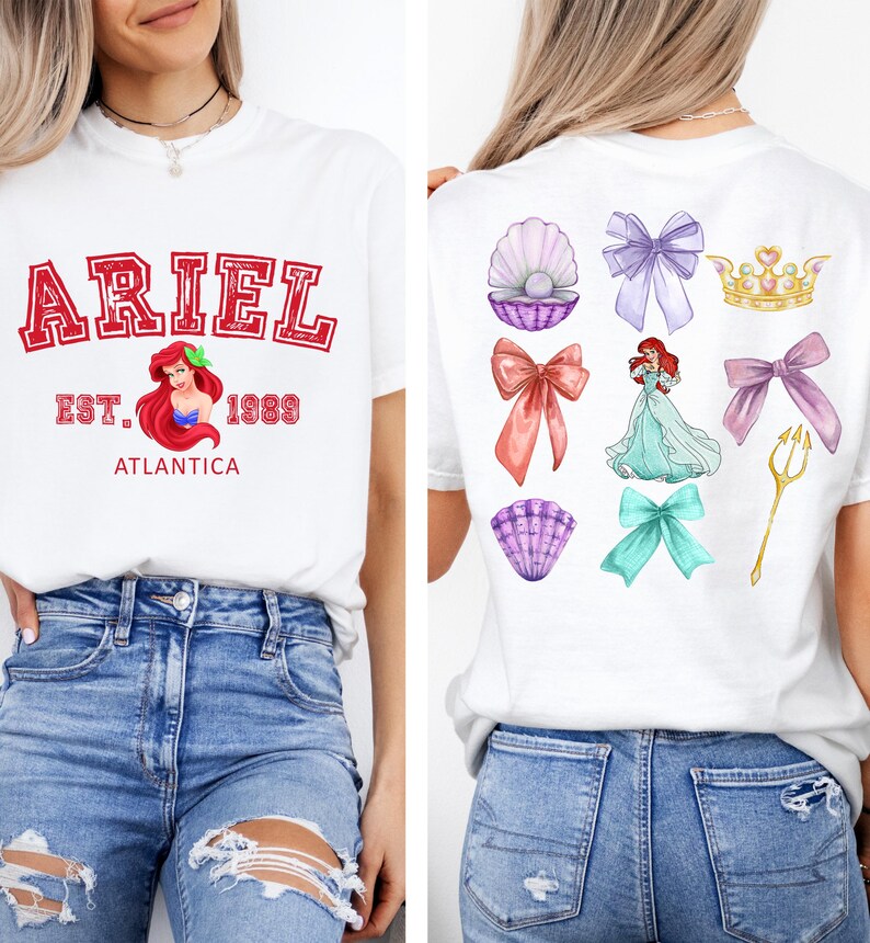 Disney Ariel sweatshirt in pastel blue with bold red varsity lettering on the front, reading 'Ariel Est. 1989 Atlantica.' The back design includes princess elements like seashells, bows, a golden trident, and an elegant illustration of