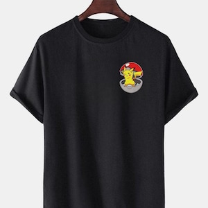 May include: Black short-sleeved t-shirt with a graphic of Pikachu in a Pokeball on the front.