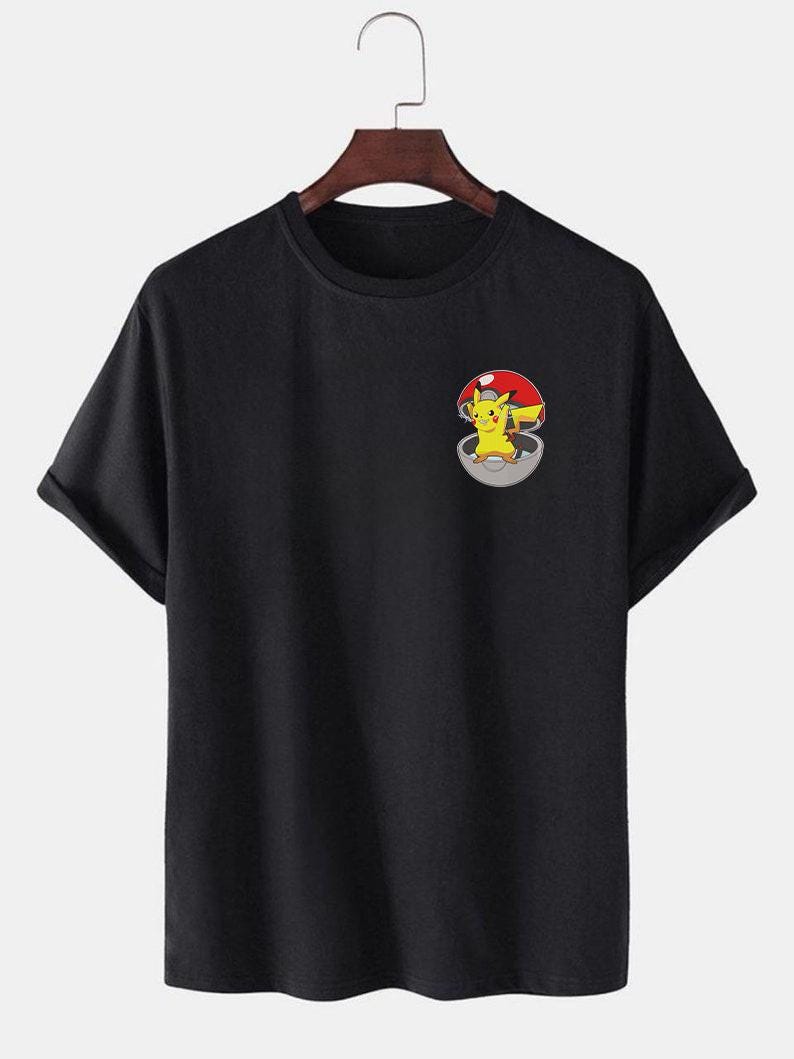 May include: Black short-sleeved t-shirt with a graphic of Pikachu in a Pokeball on the front.