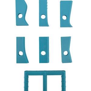 May include: A collection of seven teal-colored pottery tools, including various shaped ribs and a textured, rectangular tool with a handle. Each tool has a circular hole. The tools are designed for shaping and smoothing clay.