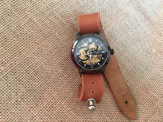 engraved skeleton watch