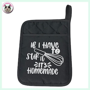 May include: Black quilted oven glove with a pocket and a hanging loop. The glove features white text that reads "IF I HAVE TO STIR IT IT'S HOMEMADE" with a whisk graphic. Designed for kitchen use.
