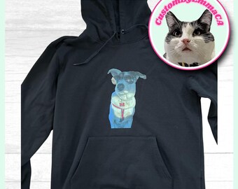 May include: Black hoodie with a graphic of a dog wearing sunglasses and a pink collar. The hoodie has a large pocket on the front and a drawstring hood.