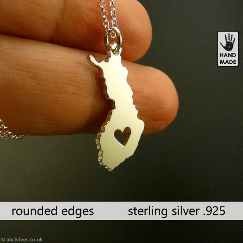 silver necklace with a heart in the shape of a finland