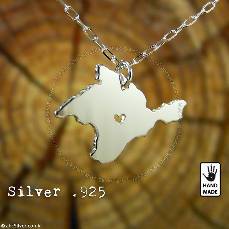 a silver necklace with the shape of a crimea map