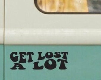 May include: A black vinyl sticker with the text "Get Lost A Lot" in a retro font style, applied to a light blue surface.