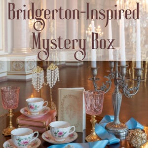May include: A collection of Bridgerton-inspired items, including teacups with floral designs, pink goblets, a candelabra, and a book. The scene is set on a table with a blue ribbon and pearl necklace, evoking a vintage aesthetic.