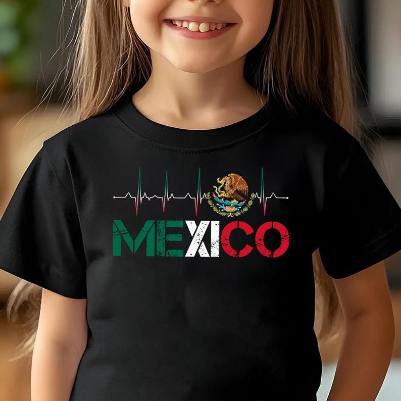 May include: Black t-shirt with the word "MEXICO" in green, white, and red, and a heartbeat graphic above. The Mexican coat of arms is also displayed. The t-shirt is worn by a child.