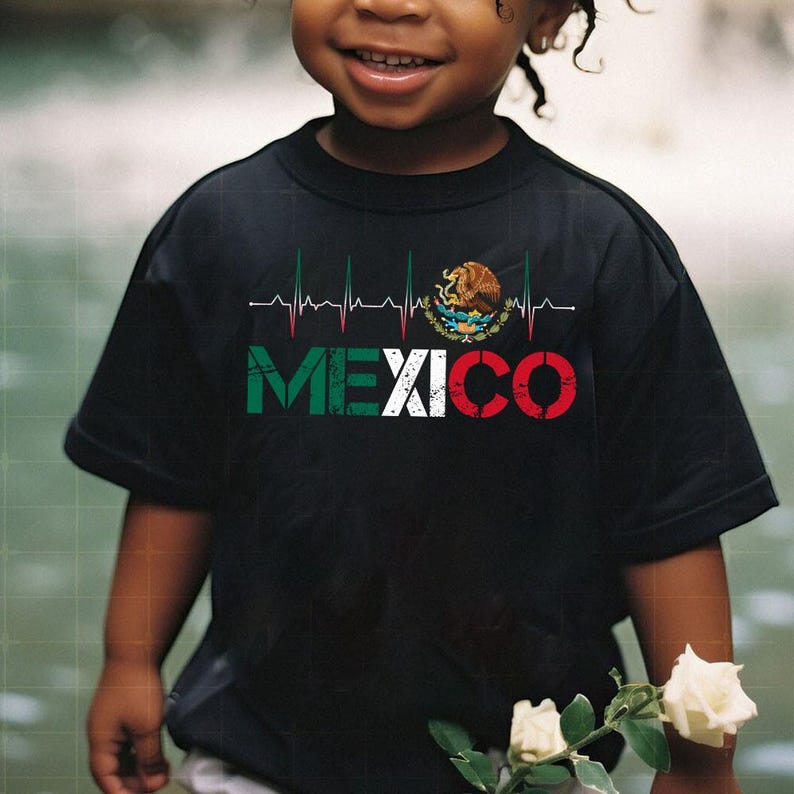May include: Black t-shirt with the word "MEXICO" in green, white, and red, and a heartbeat graphic. The shirt also features the Mexican coat of arms. The t-shirt is worn by a child.