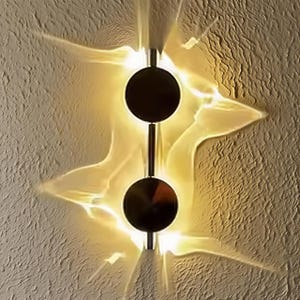 May include: A modern wall sconce with two dark circular shades connected by a vertical rod. The sconce emits a warm, diffused light, creating a starburst effect on the textured wall. The fixture is a stylish addition to any interior.