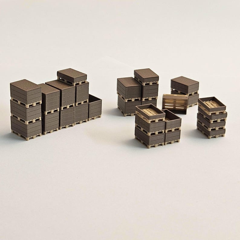 May include: Miniature brown wooden crates and pallets are stacked in various arrangements. Some crates are open, revealing the interior. The scene suggests a warehouse or shipping theme, with a focus on small-scale logistics.