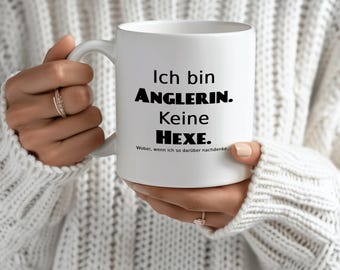 May include: White ceramic mug with black text that reads "Ich bin ANGLERIN. Keine HEXE. Wobei, wenn ich so darüber nachdenke..."