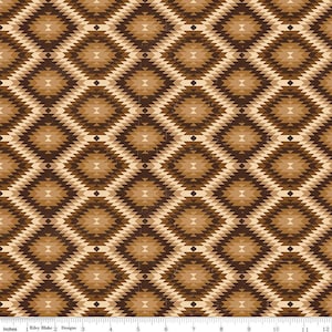 May include: A fabric with a repeating geometric pattern in shades of brown and tan. The design features diamond shapes with a central motif, creating a textured appearance. The pattern is consistent across the fabric, with a ruler at the bottom showing inches.