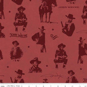 May include: Red fabric with a repeating pattern of sepia-toned illustrations of cowboys, horses, and text. The design includes images of cowboys in various poses, along with the names "John Wayne" and "John Wayne".