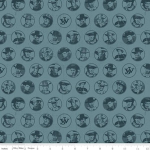 May include: A blue fabric with a repeating pattern of circular portraits of men wearing hats, interspersed with a "W" logo. The fabric has a distressed, vintage look. The bottom edge shows inch measurements.